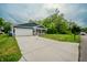 A well-maintained home features an extended driveway, a garage, and a lush green lawn at 2159 W 58Th Nw St, Indianapolis, IN 46228