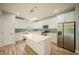 Bright kitchen with stainless steel appliances, white cabinets, and modern lighting fixtures at 2159 W 58Th Nw St, Indianapolis, IN 46228
