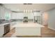 Well-lit kitchen featuring white cabinets, stainless steel appliances, and a spacious island at 2159 W 58Th Nw St, Indianapolis, IN 46228