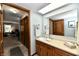 Bathroom featuring a single sink vanity with mirror and warm toned cabinets at 2442 N Willow Way, Indianapolis, IN 46268