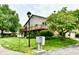 Two-story home with a well-maintained lawn, mature trees, and front-facing deck at 2442 N Willow Way, Indianapolis, IN 46268