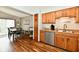 Open kitchen and dining area with modern appliances, wood cabinets, and dining table at 2442 N Willow Way, Indianapolis, IN 46268