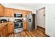 Bright kitchen featuring wood cabinets, stainless steel appliances and updated flooring at 2442 N Willow Way, Indianapolis, IN 46268