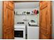 Laundry room featuring side-by-side washer and dryer with wood framed closet at 2442 N Willow Way, Indianapolis, IN 46268