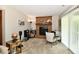 Living room featuring a brick fireplace, small table, and sliding glass door at 2442 N Willow Way, Indianapolis, IN 46268