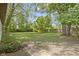 Expansive backyard is surrounded by mature trees, providing shade and privacy at 255 N Pasadena Rd, Noblesville, IN 46062
