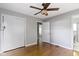 Light filled bedroom boasts hardwood floors, neutral walls, and ample closet space at 255 N Pasadena Rd, Noblesville, IN 46062