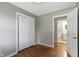 This cozy bedroom features hardwood floors, fresh paint, closet, and a view to bathroom at 255 N Pasadena Rd, Noblesville, IN 46062