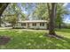 Charming single-story home with a well-maintained lawn and mature trees on a sunny day at 255 N Pasadena Rd, Noblesville, IN 46062