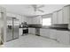 Well-lit kitchen showcasing stainless steel appliances, white cabinets, gray walls, and an elegant marble floor at 255 N Pasadena Rd, Noblesville, IN 46062