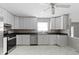 Bright kitchen featuring white cabinetry, stainless steel appliances, dark countertops, and stylish marble flooring at 255 N Pasadena Rd, Noblesville, IN 46062
