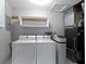 Functional laundry room with white washer and dryer, storage shelves, and modern utilities at 255 N Pasadena Rd, Noblesville, IN 46062