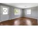 Inviting living room with light walls, a glass-paned front door, and gleaming hardwood floors at 255 N Pasadena Rd, Noblesville, IN 46062