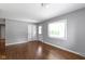 Bright living room with wood floors, closet, large window for natural light, and painted gray walls at 255 N Pasadena Rd, Noblesville, IN 46062