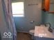 Standard bathroom featuring a single sink, toilet, and bathtub with patterned shower curtain at 26 Crescent Ct, Chesterfield, IN 46017