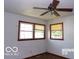 Bedroom with a ceiling fan, windows, and carpeted floors at 26 Crescent Ct, Chesterfield, IN 46017