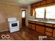 Kitchen with wood cabinets, laminate countertops, and a white electric range at 26 Crescent Ct, Chesterfield, IN 46017