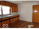 Traditional kitchen featuring wood cabinets, light countertops, and hardwood floors at 26 Crescent Ct, Chesterfield, IN 46017