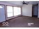 Bright living room with large windows, neutral carpet, and white trim at 26 Crescent Ct, Chesterfield, IN 46017