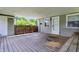 Spacious covered back patio with wood deck, offering outdoor relaxation and entertainment space at 267 S Grant Ave, Indianapolis, IN 46201