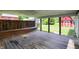 Inviting covered back patio featuring wood decking, a privacy fence, and views of the backyard at 267 S Grant Ave, Indianapolis, IN 46201