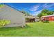 Spacious backyard featuring a covered patio area, lush green grass, and mature trees at 267 S Grant Ave, Indianapolis, IN 46201