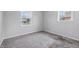 Comfortable bedroom with carpet, a sunlit window, and calming gray walls at 2908 N Routiers Ave, Indianapolis, IN 46219