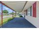 View of the spacious covered porch with red support beams and a glimpse of the peaceful neighborhood at 2908 N Routiers Ave, Indianapolis, IN 46219