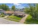 Charming single-Gathering home with red accents, well-maintained lawn, and private driveway at 2908 N Routiers Ave, Indianapolis, IN 46219