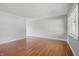 Spacious living room with hardwood floors, light gray walls, and a window to allow natural light at 2908 N Routiers Ave, Indianapolis, IN 46219