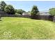 Great large, grassy backyard area with a wood fence and some shade trees at 3106 Southwest Dr, Indianapolis, IN 46241