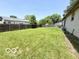 Spacious backyard with a wood fence and plenty of green grass at 3106 Southwest Dr, Indianapolis, IN 46241