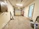 Spacious garage with concrete floor, shelving and an automatic door at 3106 Southwest Dr, Indianapolis, IN 46241