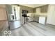 Well-lit kitchen featuring stainless steel appliances and modern flooring at 3106 Southwest Dr, Indianapolis, IN 46241