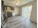 A well-lit kitchen features gray wood floors, white cabinets, a window, and sliding glass doors at 3106 Southwest Dr, Indianapolis, IN 46241