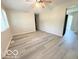 A well-lit living room features new gray floors and ceiling fan at 3106 Southwest Dr, Indianapolis, IN 46241