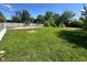 Large, grassy backyard surrounded by a chain-link fence and mature trees at 3155 Roseway Dr, Indianapolis, IN 46226