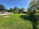 Spacious, grassy backyard with mature trees and a chain-link fence at 3155 Roseway Dr, Indianapolis, IN 46226