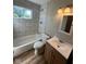 Updated bathroom with tiled shower, modern fixtures, window for natural light, and vanity with storage at 3155 Roseway Dr, Indianapolis, IN 46226