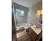 Updated bathroom with tiled shower, modern fixtures, window for natural light, and vanity with storage at 3155 Roseway Dr, Indianapolis, IN 46226