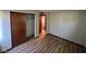 Bedroom featuring updated floors, a closet with sliding doors and an entrance to another room at 3155 Roseway Dr, Indianapolis, IN 46226