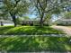 Ranch home with mature trees and lush, green grass in the front yard at 3155 Roseway Dr, Indianapolis, IN 46226
