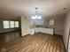 Eat-in kitchen with white cabinets, granite countertops, and vinyl flooring at 3155 Roseway Dr, Indianapolis, IN 46226