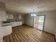 Open-concept kitchen and dining area with vinyl floors and a sliding glass door at 3155 Roseway Dr, Indianapolis, IN 46226