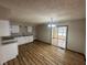 Updated kitchen featuring granite countertops, stainless steel sink, and updated lighting fixtures and a sliding door to the deck at 3155 Roseway Dr, Indianapolis, IN 46226