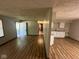 Open floor plan featuring vinyl floors, neutral walls, and a view to the kitchen at 3155 Roseway Dr, Indianapolis, IN 46226