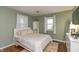 Cozy bedroom features hardwood floors, neutral walls, a queen-sized bed, and natural light at 3225 25Th St, Columbus, IN 47203