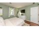 A bedroom features hardwood floors, neutral walls, a queen-sized bed, and a dresser at 3225 25Th St, Columbus, IN 47203