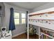 Bright bedroom with loft bed, storage shelves, and a view from the window at 3225 25Th St, Columbus, IN 47203