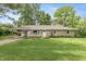 Charming ranch-style home with a well-maintained lawn and a covered carport at 3225 25Th St, Columbus, IN 47203